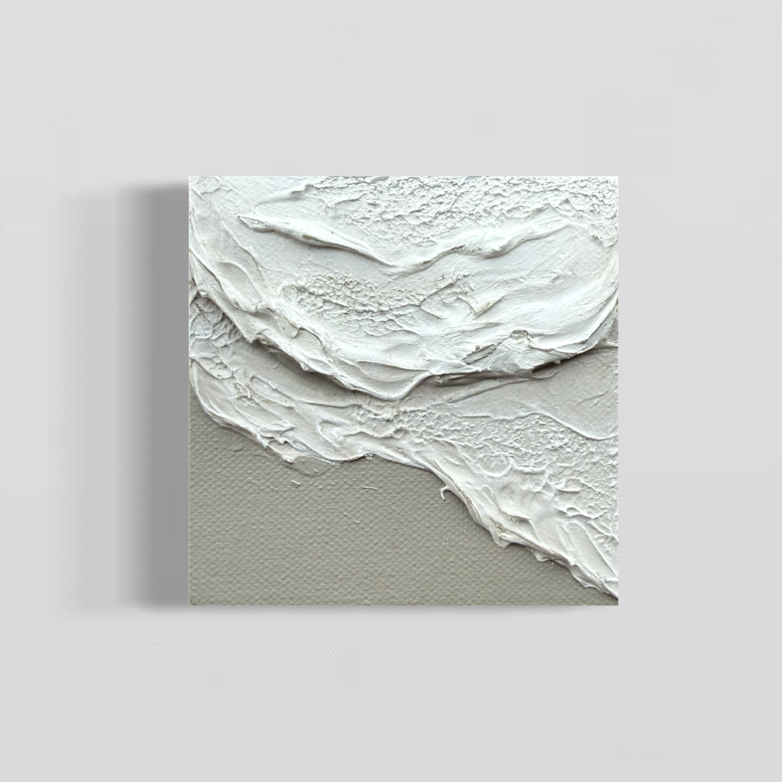 Abstract artwork with white, light grey and light cool brown wave textures on a miniature canvas