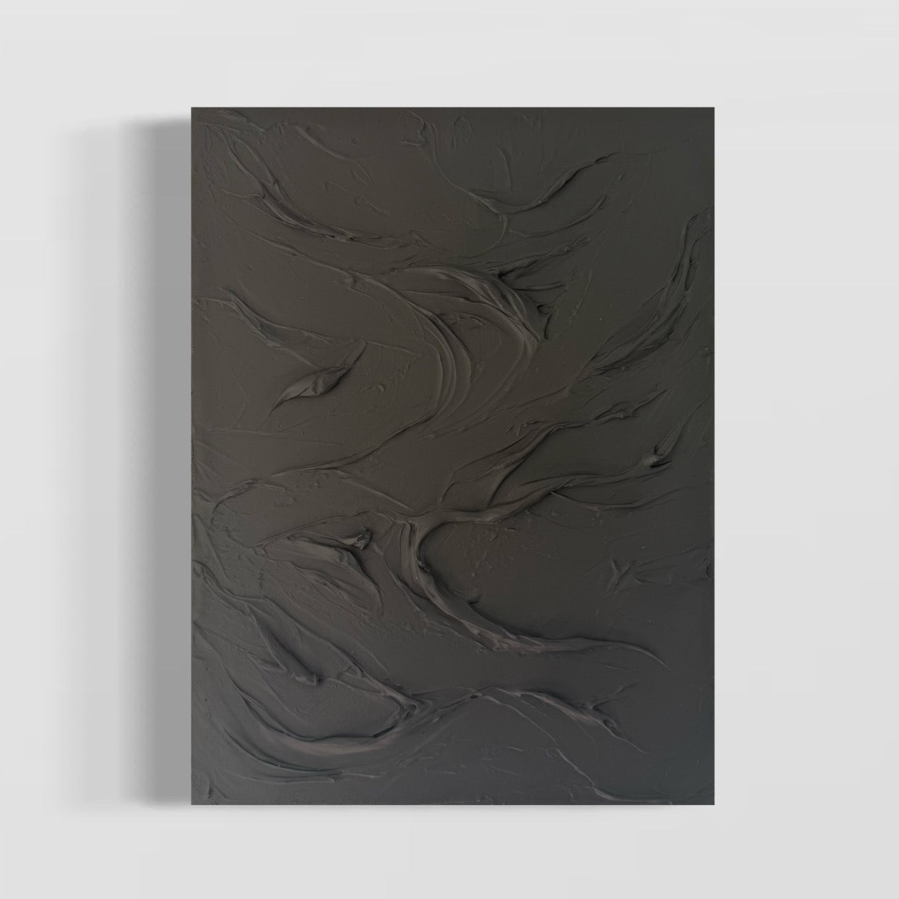 Abstract artwork with textured ridges and swirls in a monotone charcoal