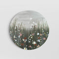 Circular artwork with field of textured flowers in the foreground and a soft grey moody sky
